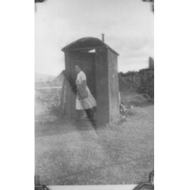 Bridget outside the 'thunderbox', Oonoonba, Townsville, 1947 
