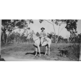 Frank Neville on horseback, with his dog, ca 1944 