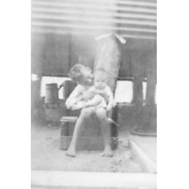 Pat Neville and Frank Neville in front of water tank, 1932 