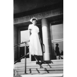 Nurse standing on steps on the Townsville General Hospital, ca 1950 