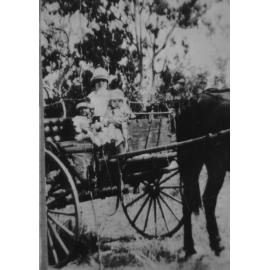 Biddy, Pat, and Frank Neville, in horse drawn vehicle, at Manton Railway Station, 1930 
