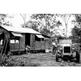 Doug and Graham McKergow beside Essex car, Marlin Street, Balgal Beach, n.d. 