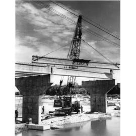 Reinforced concrete trusses being placed into position during construction of the Charles Barton bridge, Nathan Street, Townsville, 21 December 1968