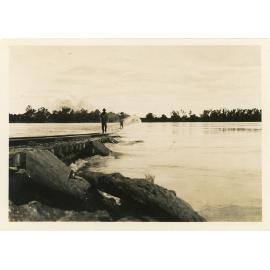 Railway men (Syd Hanlon in front) crossing over the flooded Burdekin River Railway Bridge, circa 1936