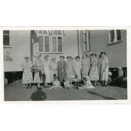 Family photograph from the Quelch Forno collection : Group of women and children posing for a photograph in front of a church