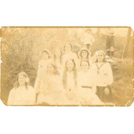 Family photograph from the Quelch Forno collection : Group of eight girls posing for a photograph