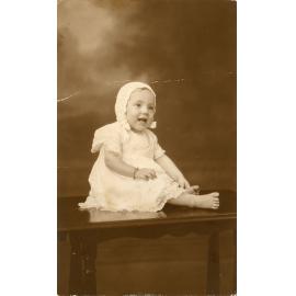 Family photograph from the Quelch Forno collection : Studio portrait of Beryl, 11 months, Christmas 1933