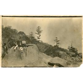 Family photograph from the Quelch Forno collection : Five men sitting on a rock on Magnetic Island