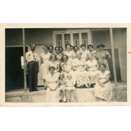 Family photograph from the Quelch Forno collection : Group of ladies posing with one man and three small children on a verandah
