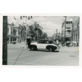 Sunshine Taxi on Denham Street, turning into Flinders street, Townsville, March 1954