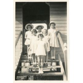 Family photograph from the Quelch Forno collection : Group of six girls standing on steps