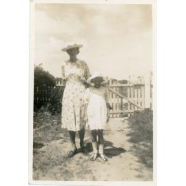 Family photograph from the Quelch Forno collection : Woman and young girlposing outdoors for a photograph