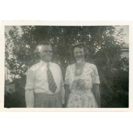 Family photograph from the Quelch Forno collection: tman and woman posing for a photograph in front of a tree