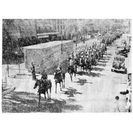 A mounted detachment of the V.D.C. (Volunteer Defence Corp) parading along Flinders Street, Townsville, 1942