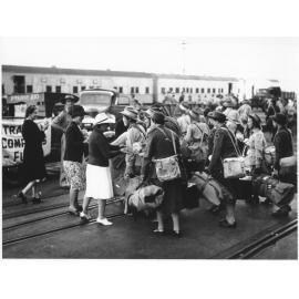 Members of the Townsville Branch of the Australian Comforts Fund distributing fruit to members of the A.A.N.S. and A.A.M.W.S. on their arrival from New Guinea for home leave on 27th June 1944