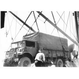 A Chevrolet army truck of 1st Australian Army Transport being loaded aboard the Liberty Ship SS James Oliver at Townsville, 18 October 1944, for shipment to Lae, New Guinea