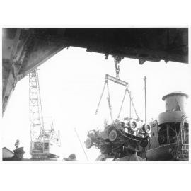 A Jeep belonging to 1st Australian Army Transport being loaded aboard the Liberty Ship SS James Oliver at Townsville, 18 October 1944, for shipment to Lae, New Guinea