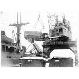A truck belonging to 1st Australian Army Transport being hoisted aboard the Liberty ship, SS James Oliver at Townsville, for shipment to Lae, New Guinea, 18 October 1944