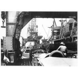 Vehicles of the 1st Australian Army Transport on the Townsville wharf, ready to be loaded aboard the Liberty ship, SS James Oliver for shipment to Lae, New Guinea, 18 October 1944