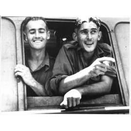 Two members of the 24th Aust. Inf. Bde. aboard a train after their arrival in Townsville on 28/1/1944 after action in the Finschhafen area of New Guinea