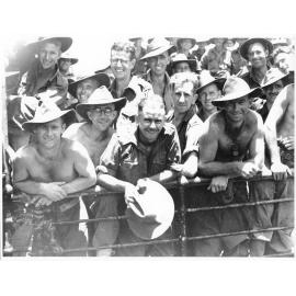 Members of the 24th Aust. Inf. Bde. aboard their transport awaiting disembarkation at Townsville on 28/1/44 after being in action in the Finschhafen area of New Guinea