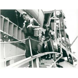 Members of the 24th Aust. Inf. Bde. disembarking at Townsville on 28/1/44 after many months of fighting in the Finschhafen area of New Guinea