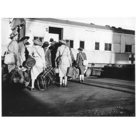 Members of the AANS and AAMWS and also 2/1 and 2/5 AGH and the 47th Australian Camp Hospital boarding a train on their arrival in Townsville from New Guinea on 27th June 1944