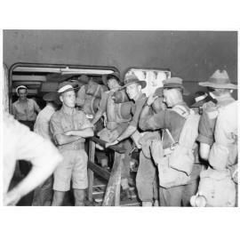 Members of the Third Australian Armoured Brigade Salvage Unit filing across the gangway of transport, Townsville, 8-10th April, 1945