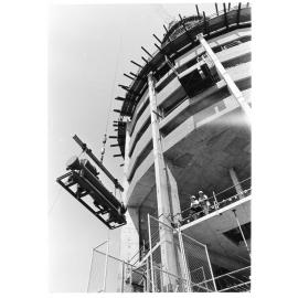 Air conditioning unit being lifted into the Hotel Townsville, 1974