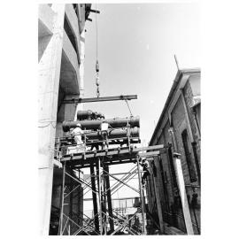 Air conditioning unit being installed into the Hotel Townsville, Flinders Street, 1974
