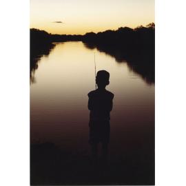 Boy fishing at sunset, Townsville, 1991