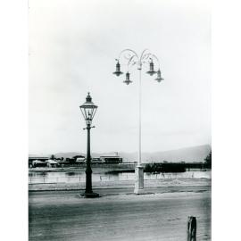 The Victoria Bridge Hotel, framed by the old gas streetlight and the new electric streetlight, Townsville, 1922 