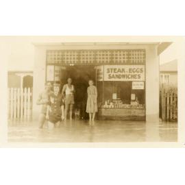 Townsville residents standing in floodwater in front of a cafe during the 1946 Townsville flood
