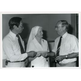 Mr. Des White of the Copper Refineries presenting a cheque for $10,000 to Philip Leong and Sister Paul Mary, Townsville