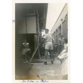 Ron Jackson on skates during a break from stocktaking at Philip Leong's Hermit Park store, Townsville, 1960