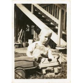 Unidentified small child with wooden toy