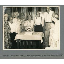 Some folk at the old peoples' home receiving part of Birthday cake from Rotary