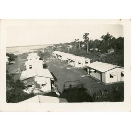 Family photograph from the Quelch Forno collection : Military barracks near a beach