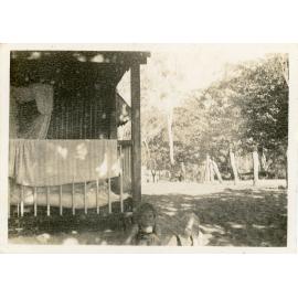 Family photograph from the Quelch Forno collection : Two young girls in front of a hut