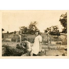 Family photograph from the Quelch Forno collection : girl on rocking horse