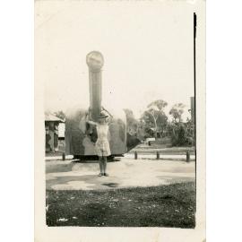 Family photograph from the Quelch Forno collection : Unidentified shirtless soldier posing for a photograph in front of a large gun