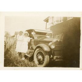 Family photograph from the Quelch Forno collection : Two women standing beside a car in a suburban yard