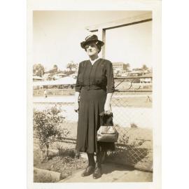 Family photograph from the Quelch Forno collection : Older lady dressed in dark dress, hat and carrying a handbag