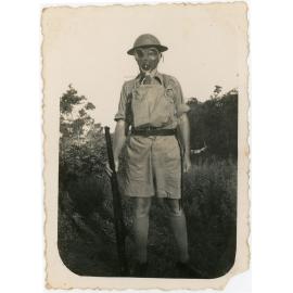 Family photograph from the Quelch Forno collection : man in military uniform and gas mask and rifle