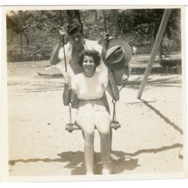 Family photograph from the Quelch Forno collection : Man and a woman on a swing