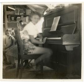 Family photograph from the Quelch Forno collection : Woman at piano