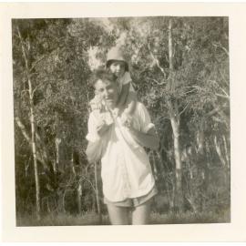 Man with a young child on his shoulders, 1950s