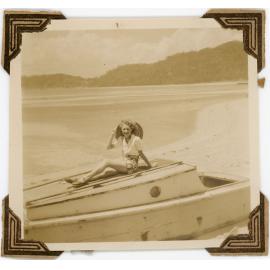 Woman sitting on a timber boat, 1950s