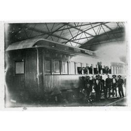 Railway employees in front of a railway carriage, Townsville
