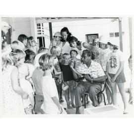 Ram Chandra demonstrating his snakes to a group of children, 1978